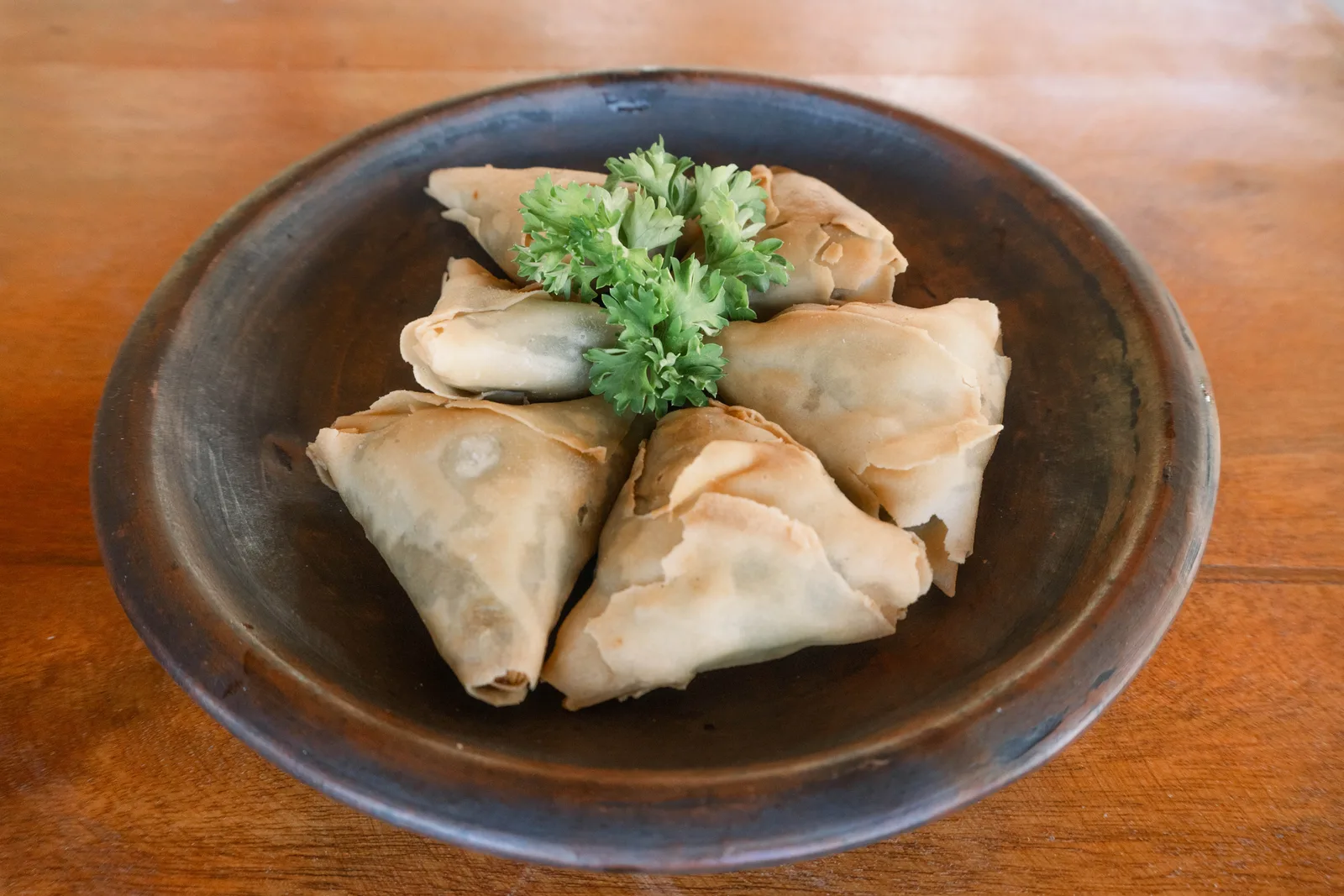 Samosas with parsley garnish